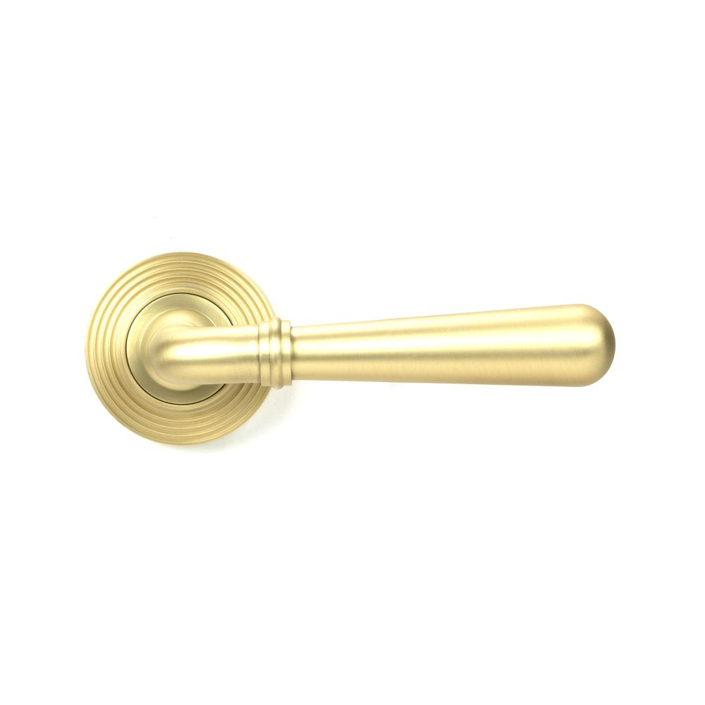 This is an image showing From The Anvil - Satin Brass Newbury Lever on Rose Set (Beehive) available from trade door handles, quick delivery and discounted prices