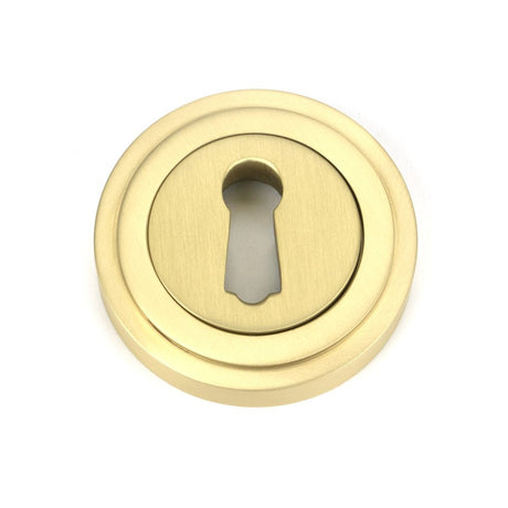 This is an image of From The Anvil - Satin Brass Round Escutcheon (Art Deco) available to order from T.H Wiggans Architectural Ironmongery in Kendal, quick delivery and discounted prices.