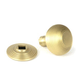 This is an image showing From The Anvil - Satin Brass Beehive Centre Door Knob available from trade door handles, quick delivery and discounted prices