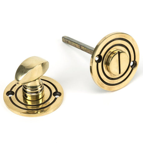 This is an image of From The Anvil - Aged Brass Round Bathroom Thumbturn available to order from T.H Wiggans Architectural Ironmongery in Kendal, quick delivery and discounted prices.