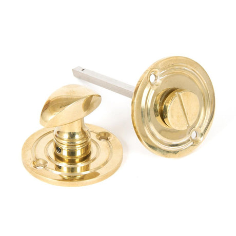 This is an image of From The Anvil - Polished Brass Round Bathroom Thumbturn available to order from T.H Wiggans Architectural Ironmongery in Kendal, quick delivery and discounted prices.