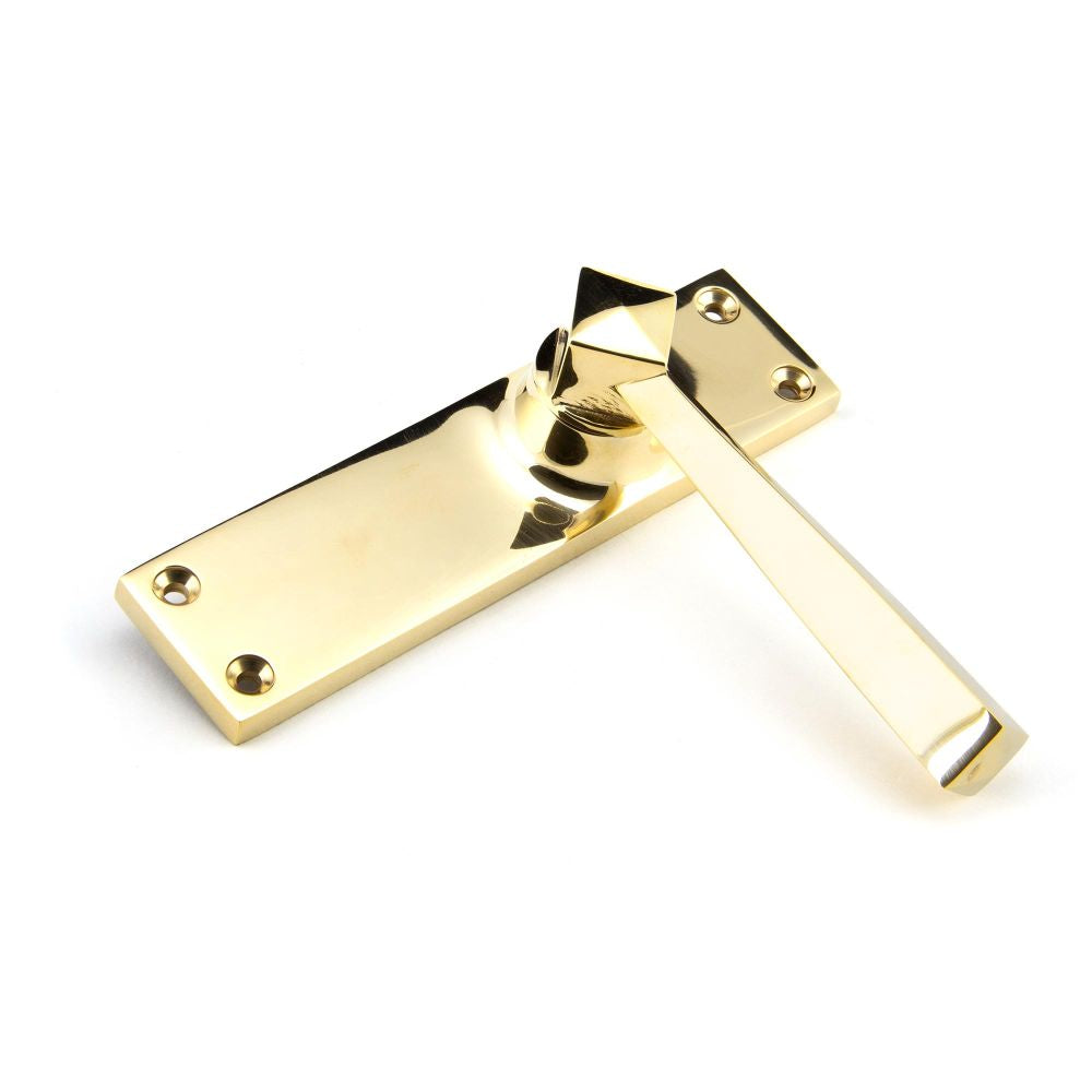 This is an image showing From The Anvil - Polished Brass Straight Lever Latch Set available from trade door handles, quick delivery and discounted prices