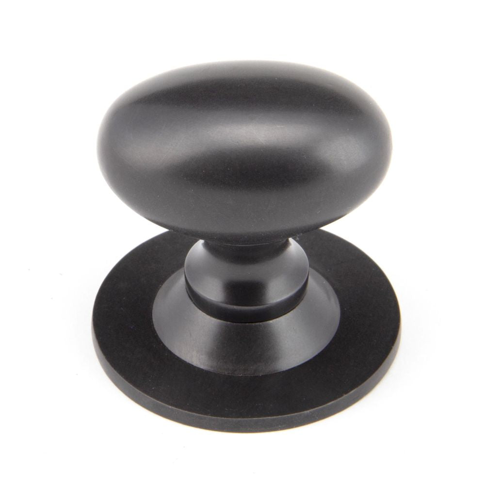This is an image showing From The Anvil - Aged Bronze Oval Cabinet Knob 40mm available from T.H Wiggans Architectural Ironmongery in Kendal, quick delivery and discounted prices
