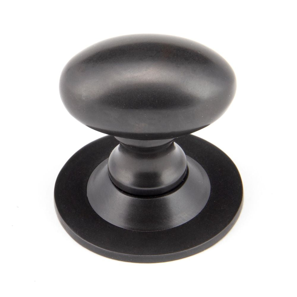 This is an image showing From The Anvil - Aged Bronze Oval Cabinet Knob 33mm available from T.H Wiggans Architectural Ironmongery in Kendal, quick delivery and discounted prices