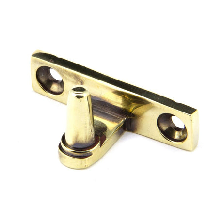 This is an image showing From The Anvil - Aged Brass Cranked Stay Pin available from T.H Wiggans Architectural Ironmongery in Kendal, quick delivery and discounted prices