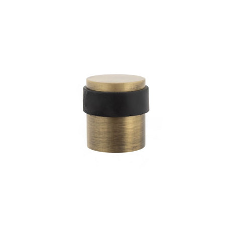 This is an image of Atlantic Cylinder Premium Floor Mounted Door Stop - Matt Antique Brass available to order from T.H Wiggans Architectural Ironmongery in Kendal, quick delivery and discounted prices.