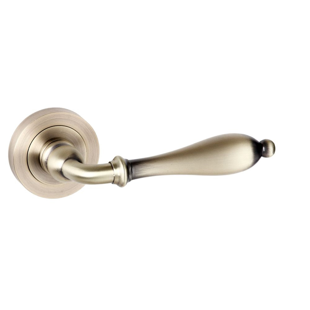This is an image of Old English Wrexham Lever on Round Rose - Matt Antique Brass available to order from T.H Wiggans Architectural Ironmongery in Kendal, quick delivery and discounted prices.
