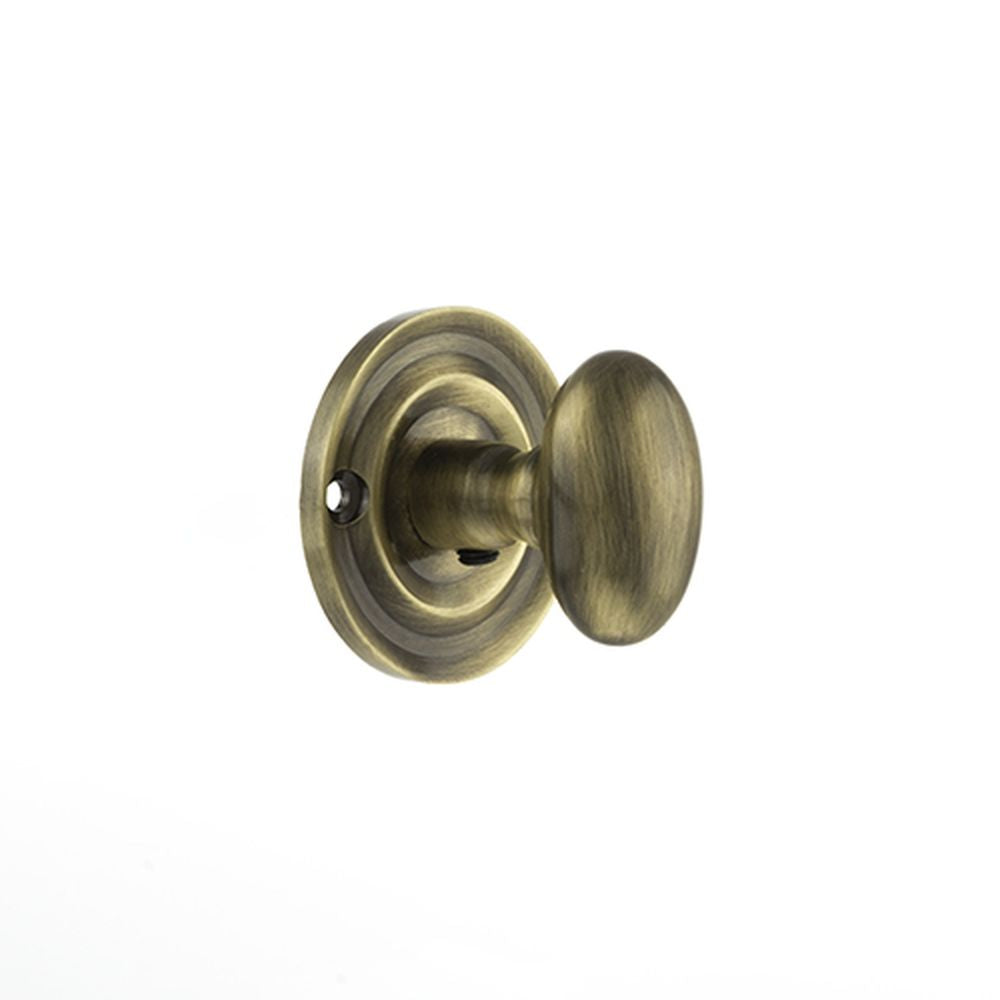 This is an image of Old English Solid Brass Oval WC Turn and Release - Antique Brass available to order from T.H Wiggans Architectural Ironmongery in Kendal, quick delivery and discounted prices.