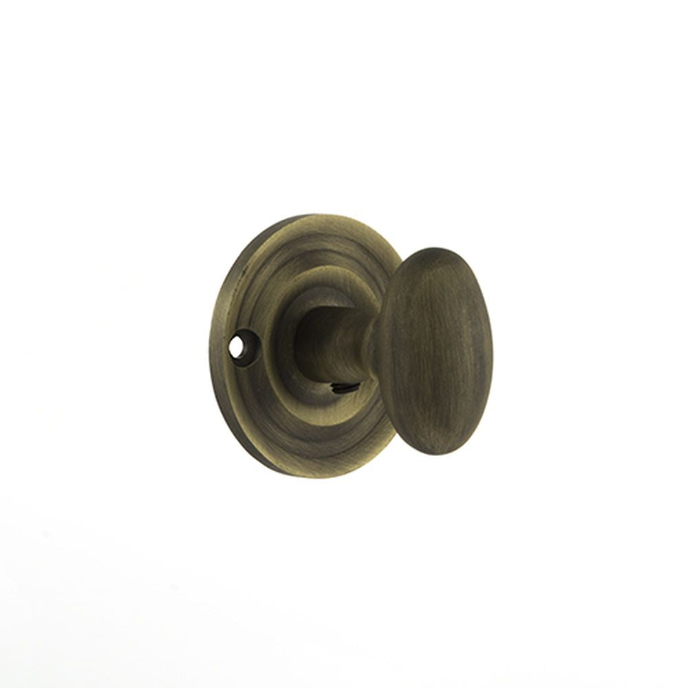 This is an image of Old English Solid Brass Oval WC Turn and Release - Matt Antique Brass available to order from T.H Wiggans Architectural Ironmongery in Kendal, quick delivery and discounted prices.