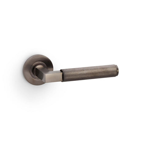 This is an image showing Alexander & Wilks Hurricane Knurled Lever on Round Rose - Dark Bronze PVD aw200dbzpvd available to order from T.H Wiggans Ironmongery in Kendal, quick delivery and discounted prices.