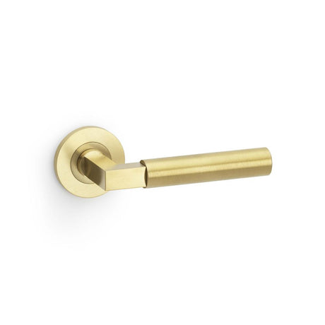 This is an image showing Alexander & Wilks Hurricane Plain Lever on Round Rose - Satin Brass PVD aw201sbpvd available to order from T.H Wiggans Ironmongery in Kendal, quick delivery and discounted prices.