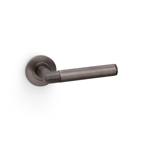 This is an image showing Alexander & Wilks Harrier Knurled Lever on Round Rose - Dark Bronze PVD aw210dbzpvd available to order from T.H Wiggans Ironmongery in Kendal, quick delivery and discounted prices.