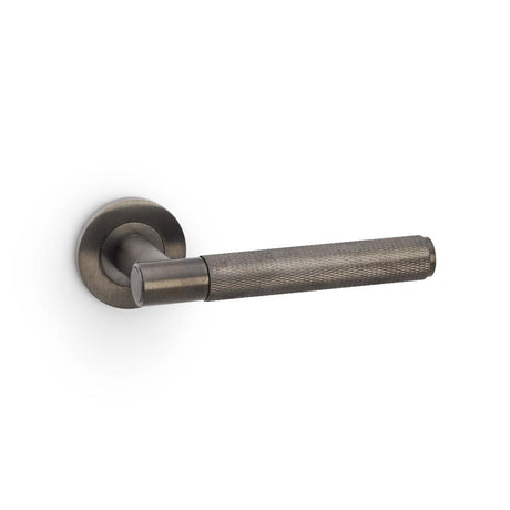 This is an image showing Alexander & Wilks Spitfire Knurled Lever on Round Rose - Dark Bronze PVD aw220dbzpvd available to order from T.H Wiggans Ironmongery in Kendal, quick delivery and discounted prices.