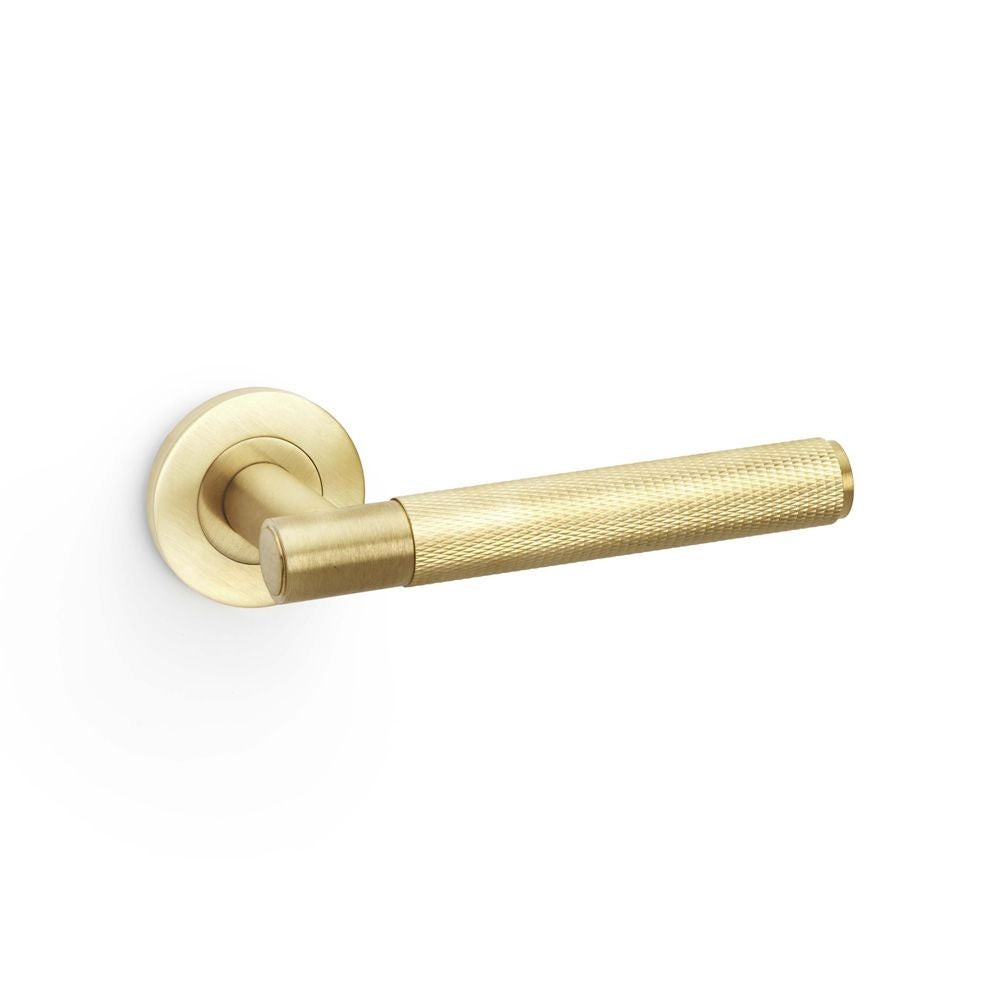 This is an image showing Alexander & Wilks Spitfire Knurled Lever on Round Rose - Satin Brass PVD aw220sbpvd available to order from T.H Wiggans Ironmongery in Kendal, quick delivery and discounted prices.