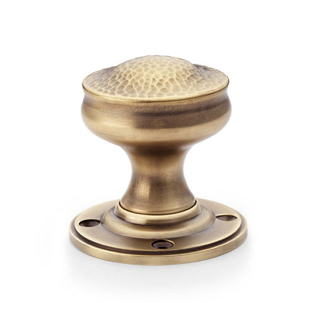 This is an image showing Alexander & Wilks Hammered Mortice Knob - Antique Brass aw302-50-ab available to order from T.H Wiggans Ironmongery in Kendal, quick delivery and discounted prices.
