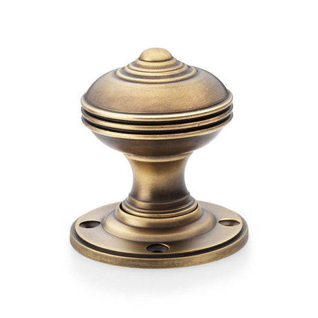 This is an image showing Alexander & Wilks Romeo Mortice Knob - Antique Brass aw304-50-ab available to order from T.H Wiggans Ironmongery in Kendal, quick delivery and discounted prices.