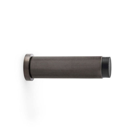 This is an image showing Alexander & Wilks Reeded Projection Door Stop - Dark Bronze PVD aw602-75-dbzpvd available to order from T.H Wiggans Ironmongery in Kendal, quick delivery and discounted prices.