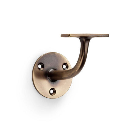 This is an image showing Alexander & Wilks Architectural Handrail Bracket - Antique Brass aw750ab available to order from T.H Wiggans Ironmongery in Kendal, quick delivery and discounted prices.