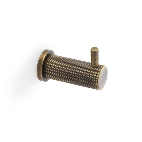 This is an image showing Alexander & Wilks Brunel Knurled Coat Hook - Antique Brass aw775ab available to order from T.H Wiggans Ironmongery in Kendal, quick delivery and discounted prices.