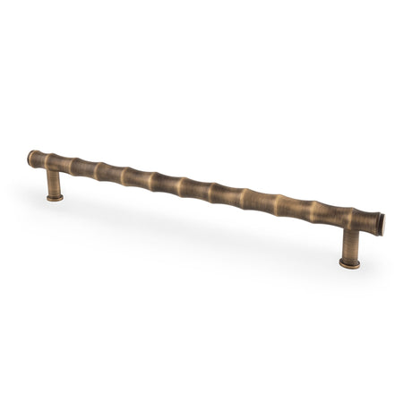 This is an image showing Alexander & Wilks Crispin Bamboo T-bar Cupboard Pull Handle - Antique Brass - 224mm Centres aw809b-224-ab available to order from T.H Wiggans Ironmongery in Kendal, quick delivery and discounted prices.