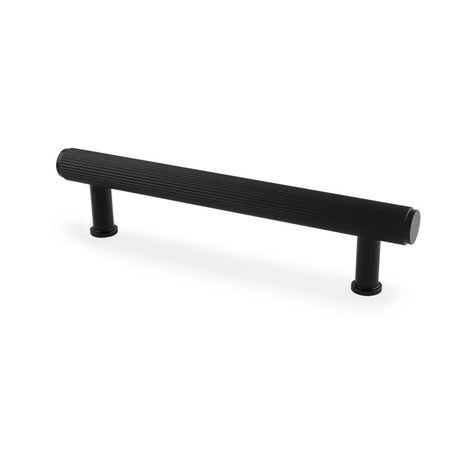 This is an image showing Alexander & Wilks Crispin Reeded T-bar Cupboard Pull Handle - Black - 128mm aw809r-128-bl available to order from T.H Wiggans Ironmongery in Kendal, quick delivery and discounted prices.