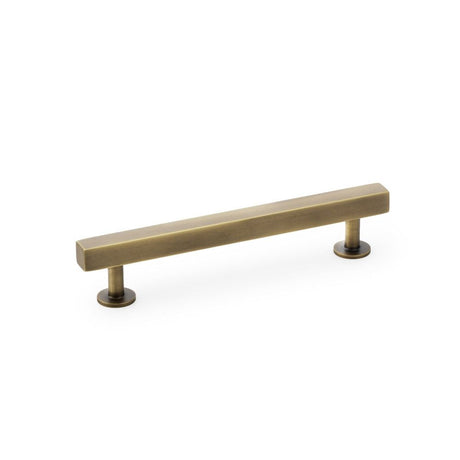This is an image showing Alexander & Wilks Square T-Bar Cabinet Pull Handle - Antique Brass - Centres 128mm aw815-128-ab available to order from T.H Wiggans Ironmongery in Kendal, quick delivery and discounted prices.