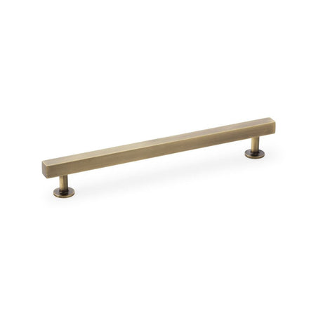 This is an image showing Alexander & Wilks Square T-Bar Cabinet Pull Handle - Antique Brass - Centres 192mm aw815-192-ab available to order from T.H Wiggans Ironmongery in Kendal, quick delivery and discounted prices.