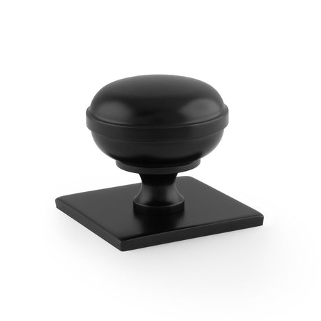 This is an image showing Alexander & Wilks Quantock Cupboard Knob on Square Backplate - Black - 38mm aw826-38-bl available to order from T.H Wiggans Ironmongery in Kendal, quick delivery and discounted prices.
