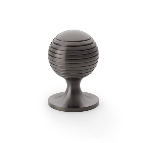 This is an image showing Alexander & Wilks Caesar Cupboard Knob on Round Rose - Dark Bronze PVD - 38mm aw832-38-dbzpvd available to order from T.H Wiggans Ironmongery in Kendal, quick delivery and discounted prices.