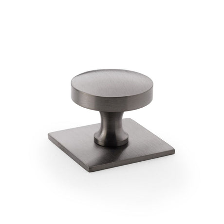 This is an image showing Alexander & Wilks Bullion Cupboard Knob on Square Backplate - Dark Bronze PVD aw835-38-dbzpvd available to order from T.H Wiggans Ironmongery in Kendal, quick delivery and discounted prices.