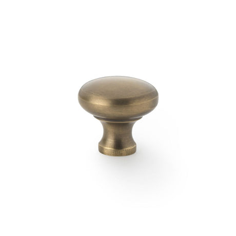 This is an image showing Alexander & Wilks Wade Round Cupboard Knob - Antique Brass - 32mm aw836-32-ab available to order from T.H Wiggans Ironmongery in Kendal, quick delivery and discounted prices.