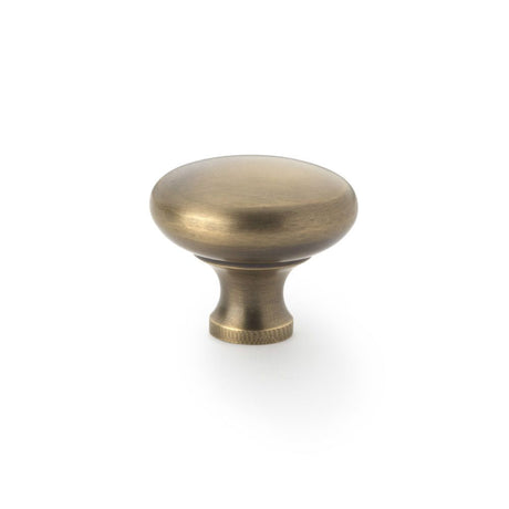 This is an image showing Alexander & Wilks Wade Round Cupboard Knob - Antique Brass - 38mm aw836-38-ab available to order from T.H Wiggans Ironmongery in Kendal, quick delivery and discounted prices.