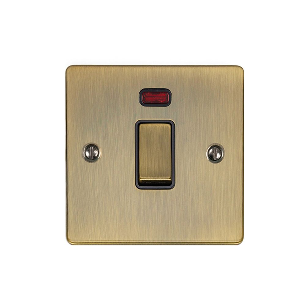 This is an image showing Eurolite Enhance Decorative 20Amp Switch with Neon Indicator - Antique Brass (With Black Trim) en20aswnabb available to order from T.H. Wiggans Ironmongery in Kendal, quick delivery and discounted prices.