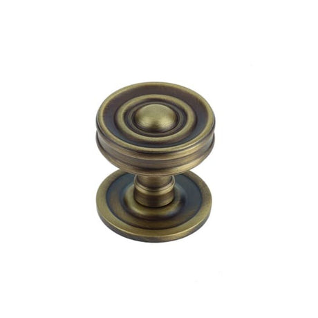 This is an image of a Burlington - Bloomury cupboard knob - Antique Brass that is availble to order from T.H Wiggans Architectural Ironmongery in Kendal in Kendal.