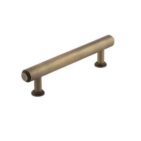 This is an image of a Burlington - Belgrave Cabinet Handle 128mm CTC - Antique Brass that is availble to order from T.H Wiggans Architectural Ironmongery in Kendal in Kendal.