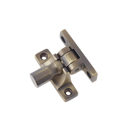 This is an image of a Burlington - Brighton sash fastener - Antique Brass that is availble to order from T.H Wiggans Architectural Ironmongery in Kendal in Kendal.