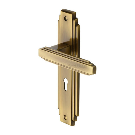 This is an image of a Heritage Brass - Door Handle Lever Lock Astoria Design Antique Brass Finish, ast5900-at that is available to order from T.H Wiggans Ironmongery in Kendal.