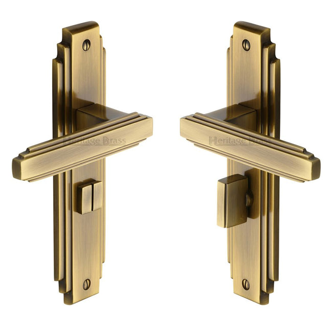 This is an image of a Heritage Brass - Door Handle for Bathroom Astoria Design Antique Brass Finish, ast5930-at that is available to order from T.H Wiggans Ironmongery in Kendal.