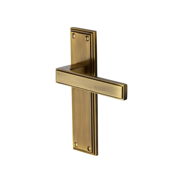 This is an image of a Heritage Brass - Door Handle Lever Latch Atlantis Design Antique Brass Finish, atl5710-at that is available to order from T.H Wiggans Ironmongery in Kendal.