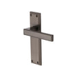 This is an image of a Heritage Brass - Door Handle Lever Latch Atlantis Design Matt Bronze Finish, atl5710-mb that is available to order from T.H Wiggans Ironmongery in Kendal.
