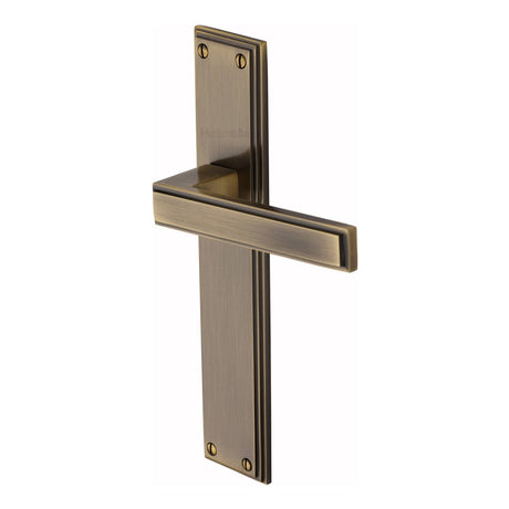 This is an image of a Heritage Brass - Atlantis Long Lever Latch Antique Brass finish, atl6710-at that is available to order from T.H Wiggans Ironmongery in Kendal.