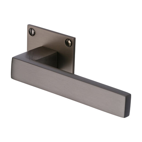 This is an image of a Heritage Brass - Door Handle Lever Latch on Square Rose Delta BH Design Matt Bronze finish, bau1928-mb that is available to order from T.H Wiggans Ironmongery in Kendal.