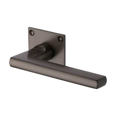 This is an image of a Heritage Brass - Door Handle Lever Latch on Square Rose Trident Design Matt Bronze finish, bau2910-mb that is available to order from T.H Wiggans Ironmongery in Kendal.