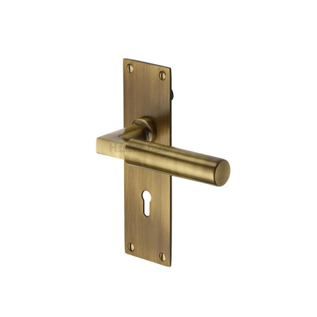 This is an image of a Heritage Brass - Door Handle Lever Lock Bauhaus Design Antique Brass Finish, bau7300-at that is available to order from T.H Wiggans Ironmongery in Kendal.
