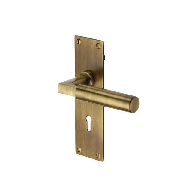 This is an image of a Heritage Brass - Door Handle Lever Lock Bauhaus Design Antique Brass Finish, bau7300-at that is available to order from T.H Wiggans Ironmongery in Kendal.