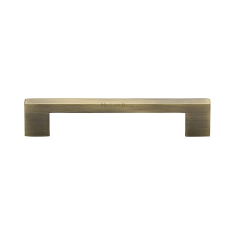 This is an image of a Heritage Brass - Cabinet Pull Metro Design 128mm CTC Antique Brass Finish, c0337-128-at that is available to order from T.H Wiggans Ironmongery in Kendal.