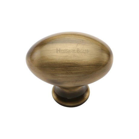 This is an image of a Heritage Brass - Cabinet Knob Victorian Oval Design 32mm Antique Brass Finish, c114-32-at that is available to order from T.H Wiggans Ironmongery in Kendal.