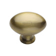 This is an image of a Heritage Brass - Cabinet Knob Victorian Oval Design 38mm Antique Brass Finish, c114-38-at that is available to order from T.H Wiggans Ironmongery in Kendal.