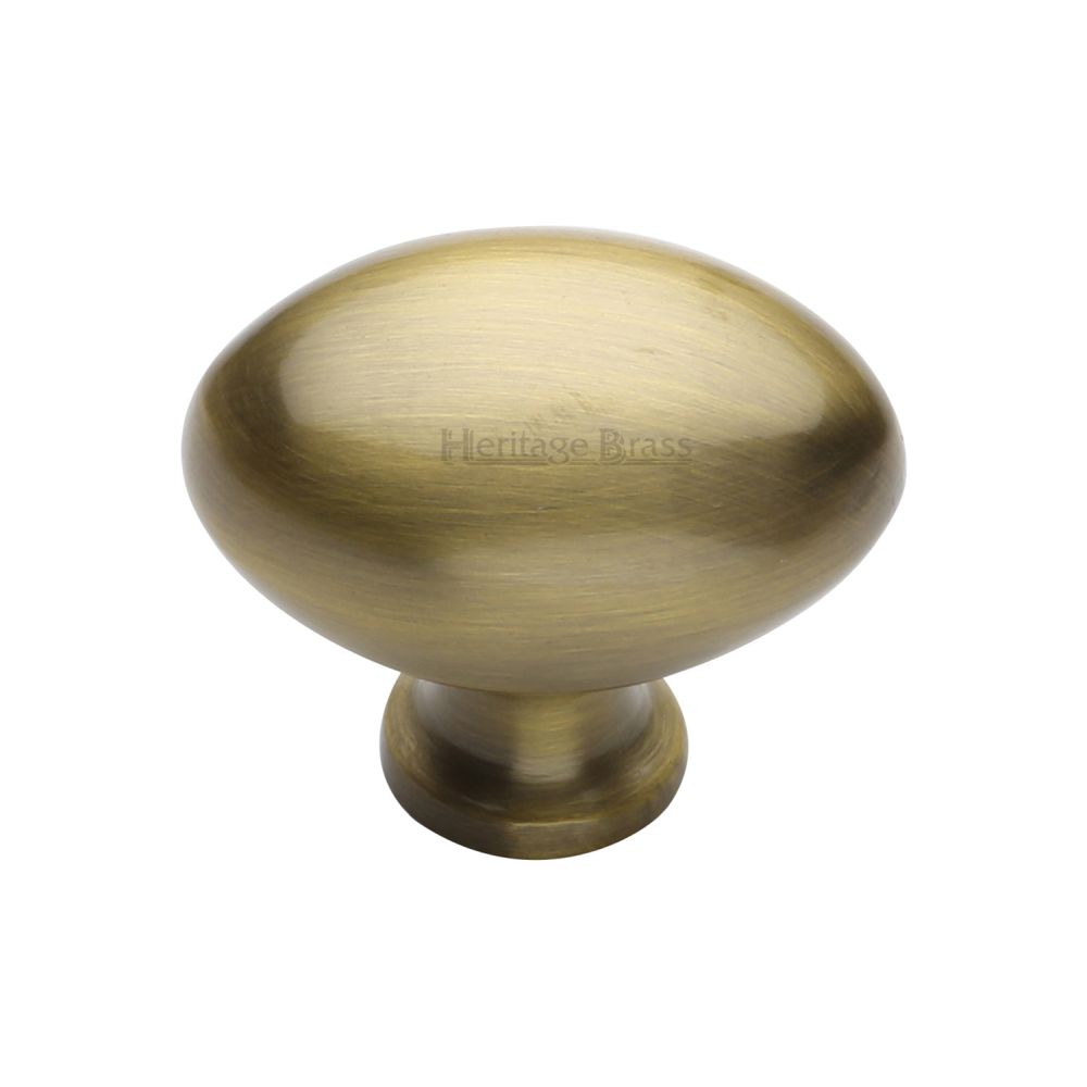 This is an image of a Heritage Brass - Cabinet Knob Victorian Oval Design 38mm Antique Brass Finish, c114-38-at that is available to order from T.H Wiggans Ironmongery in Kendal.