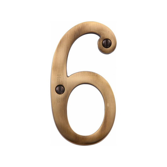 This is an image of a Heritage Brass - Numeral 6 Face Fix 76mm (3") Antique Brass Finish, c1560-6-at that is available to order from T.H Wiggans Ironmongery in Kendal.